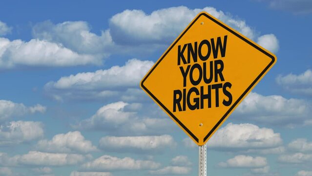 Know Your Rights construction road sign over timelapse cloudscape.	