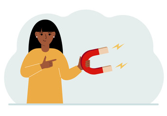Obraz premium A woman holds a huge magnet in his hand, attracts new customers, money and ideas. Inbound business marketing technologies, lead generation concept.