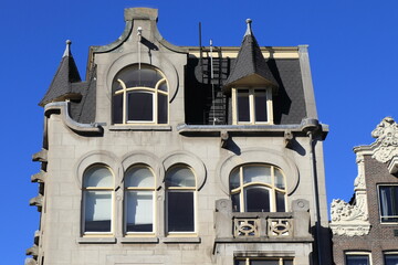 Fototapeta na wymiar Amsterdam Damrak Street Historic Grey Building Exterior Close Up, Netherlands