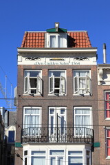 Amsterdam Damrak Street Historic House Facade with Stone Tablet Depicting a Golden Salmon, Netherlands
