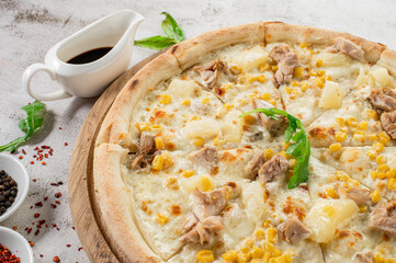 Hawaiian pizza with chicken meat, pineapple and corn