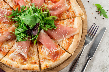 Meat pizza with ham and cheese on the white concrete background