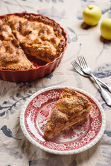 Classic American apple pie on linen tablecloth. Homemade american autumn dessert: sliced apple pie (tart) with cinnamon. Selective focus - 539746922