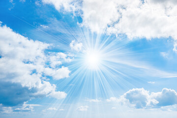 Naklejka na ściany i meble Sun with rays on blue sky