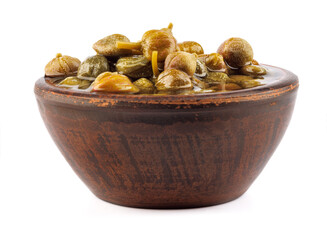 Clay bowl full of fragrant capers isolated on white background. Full clipping path.