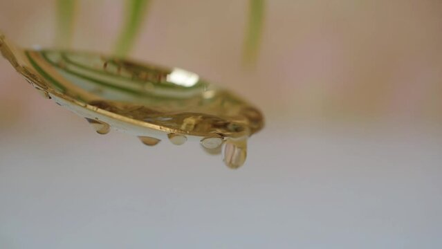 water droplets on a golden spoon