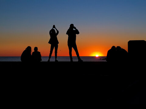 People taking photos of sunset
