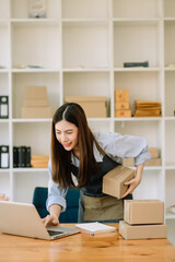 Fototapeta na wymiar Small business entrepreneur SME freelance woman working at home office, BOX,tablet and laptop online, marketing, packaging, delivery, e-commerce concept.