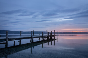 Fototapeta na wymiar Magnificent sunset wooden Pier on the lake. A tranquil sunset over a Varna lake.