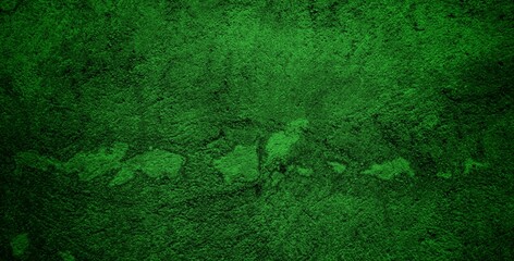 Fototapeta premium A textured green grunge background with dark patches and rough surface