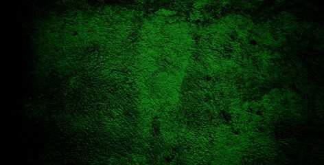 Fototapeta premium A textured green grunge background with dark patches and rough surface