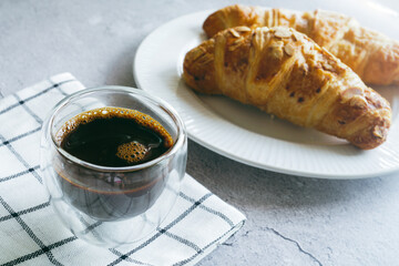 Croissants and espresso shots on the table for a light breakfast. - 539760703