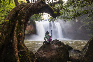 Young woman hiking on beautiful waterfall in Khao Yai National Park (Haew Suwat Waterfall), Nakhon Ratchasima  province, ThaiLand.