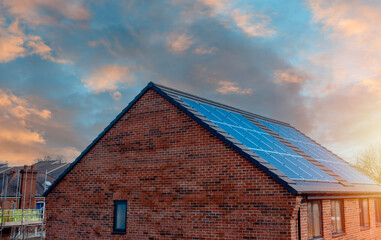 Photovoltaic solar panels on the roof of new house. Roof with solar panels
