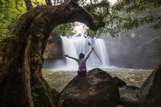 Young woman hiking on beautiful waterfall in Khao Yai National Park (Haew Suwat Waterfall), Nakhon Ratchasima  province, ThaiLand.
