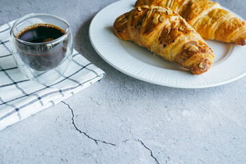 Croissants and espresso shots on the table for a light breakfast. - 539761504