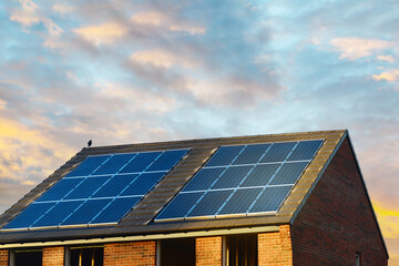 Fototapeta premium Photovoltaic solar panels on the roof of new house. Roof with solar panels