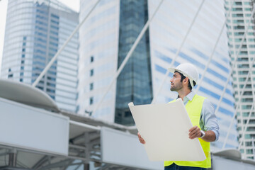 Fototapeta premium Man engineer standing on construction site. Engineer working on outdoor project