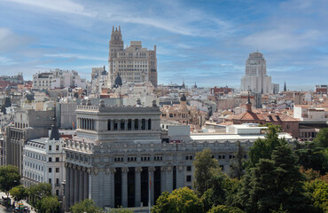 Fototapeta na wymiar Skyline of Madrid, Spain, Europe. View from the tower of Cybele Palace. Buildings, towers, and colorful rooftops. European capital city skyline. Iconic buildings of Gran Vía avenue.