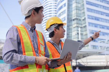 Engineers shaking hands at construction site.