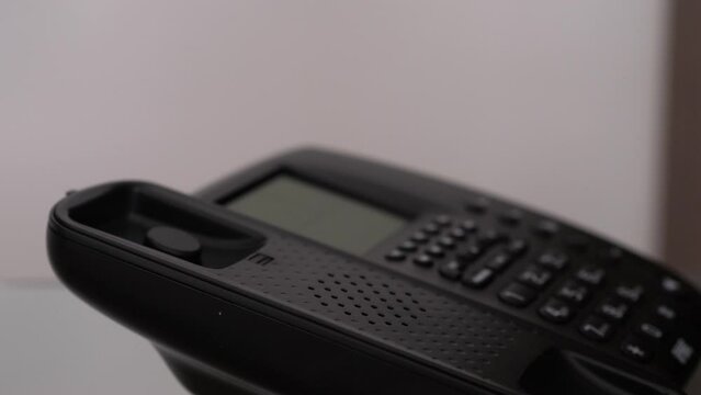 Close up of a female doctor's hand answering a phone call
