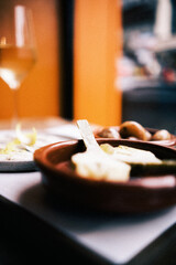 A dining scene including various tapas by window light.