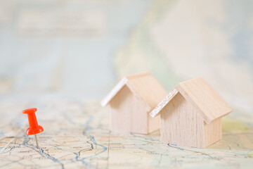 Selective focus of Red pin and house model on map background  for real estate concept