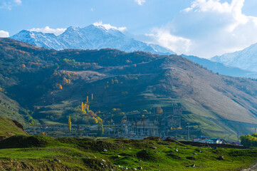 Autumn landscape in the mountains. Mountain peaks with white clouds in the sky. Mountain gorges. View of the mountain peaks. Nature in the mountains. Electrical substation in the mountains.