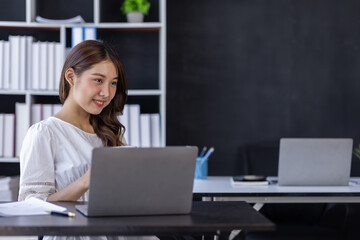 Fototapeta na wymiar Happiness Entrepreneur beautiful business asian young woman working with laptop at workplace, Small Business Startup, online banking tax, accounting, financial concept.