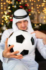 Young male Arab holding a soccer ball
