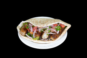 Chicken Sheftali in pita bread in a white plate on a black background