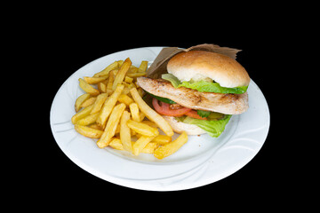 Grilled chicken burger in a white plate on a black background