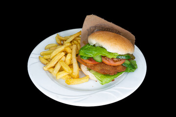 Fried chicken burger in a white plate on a black background