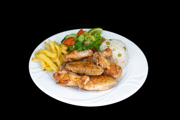 Grilled chicken wings in a white plate on a black background