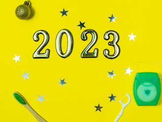 2023 and dental concept. Close up view photo with 2023 and white dental floss, stick and toothbrush...