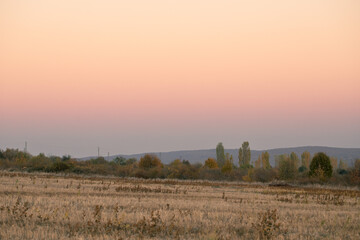 Fototapeta na wymiar Postoral view. Autumn fields at sunset.