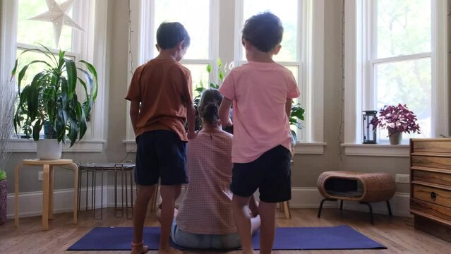 Two children sons brothers lifestyle bother their mother at home indoor meditation yoga fatigue overwork gender perspective single mom funny scene