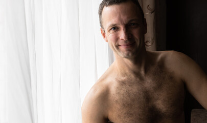 Fototapeta na wymiar Portrait of smiling naked young European man