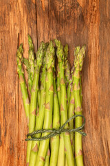 Fresh picked asparagus on on an old farm table