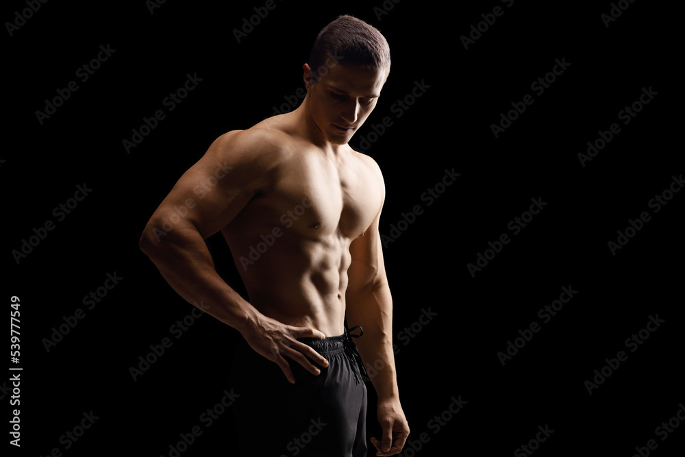 Sticker Topless young muscular man isolated on black