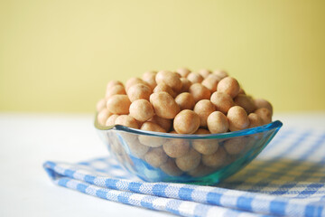indonesia peanuts in a bowl on table top down .