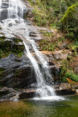 Fototapeta na wymiar Big waterfall with small lake for bathing in rainforest inside Rio de Janeiro city, Brazil