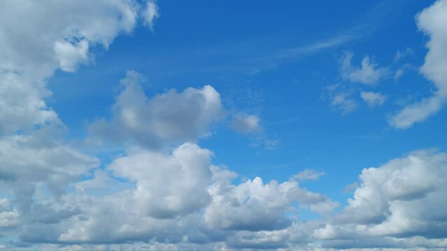 Clearing day and good windy weather. Blue sky and light fluffy cumulus cirrus on different layers clouds. Timelapse.