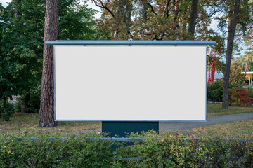 Large blank banner with white copy space for mockup standing at urban park in autumn season outdoor