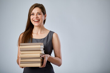 Smiling woman holding pile books. Isolated advertising portrait.