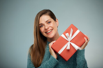 Happy smiling woman with red present. Advertising female studio portrait.