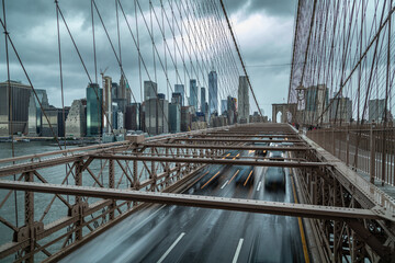 Fototapeta premium Moving cars on the Brooklyn Bridge, New York street life