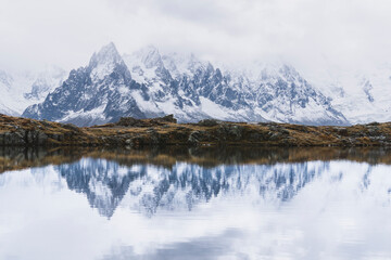 mountain landscape with snow reflection in lake