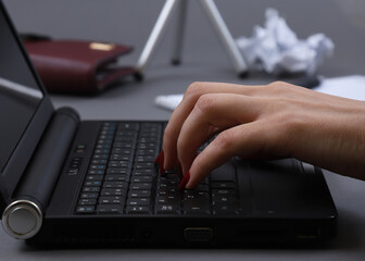 Obraz na płótnie Canvas female fingers on a laptop keyboard. Shallow depth of field