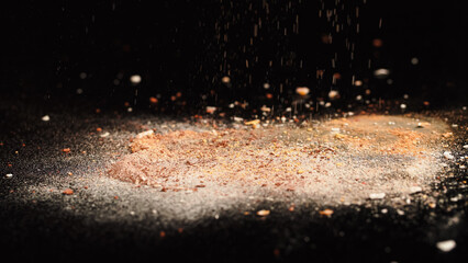Close up view of crashed beige face powder on black background